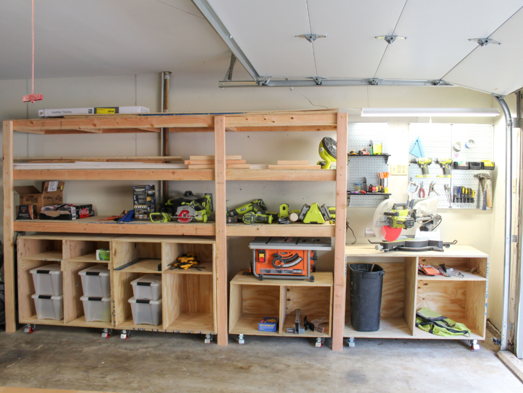 Organized garage with wall-mounted shelves, overhead storage racks, and pegboard tool organizer